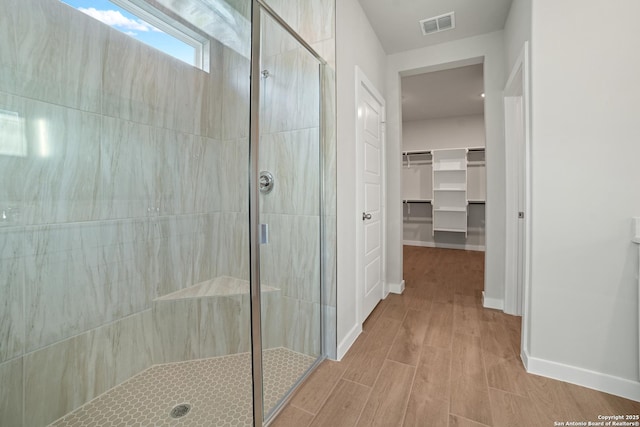 211 Ryan Xing, San Antonio, TX 78253 - full bathroom featuring a stall shower, wood finished floors, baseboards, and a spacious closet