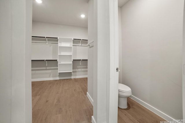 211 Ryan Xing, San Antonio, TX 78253 - bathroom featuring wood finished floors, baseboards, toilet, recessed lighting, and a walk in closet