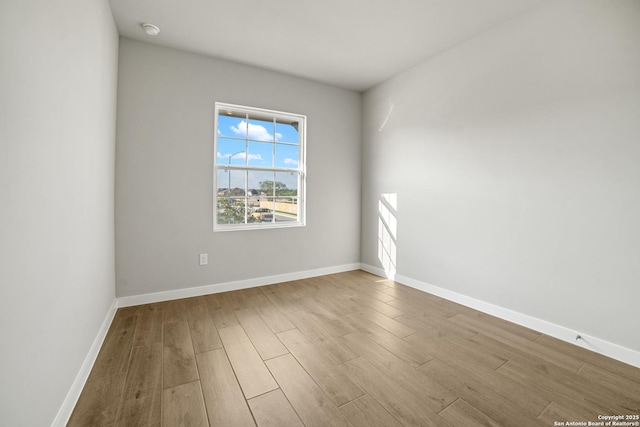 211 Ryan Xing, San Antonio, TX 78253 - empty room with wood finished floors, baseboards, and a smoke detector