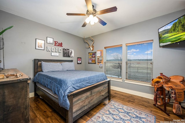 bedroom featuring ceiling fan, baseboards, and dark wood finished floors