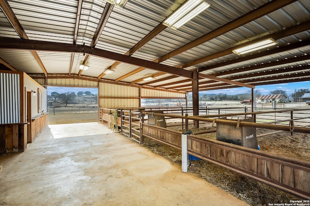 view of horse barn featuring a rural view