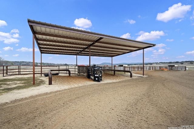 view of parking / parking lot with a rural view