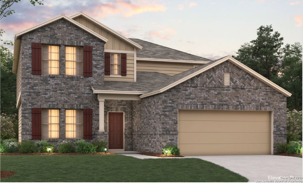 view of front of house with a garage and a yard