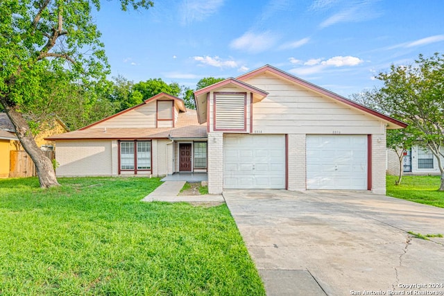 view of front of property featuring a garage and a front lawn