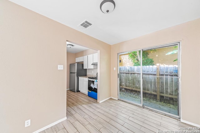 spare room featuring light wood-type flooring