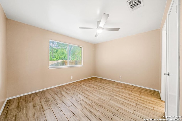 empty room with ceiling fan and light wood-type flooring