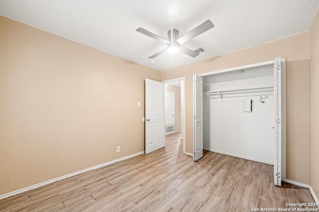 unfurnished bedroom featuring ceiling fan, a closet, and light hardwood / wood-style flooring