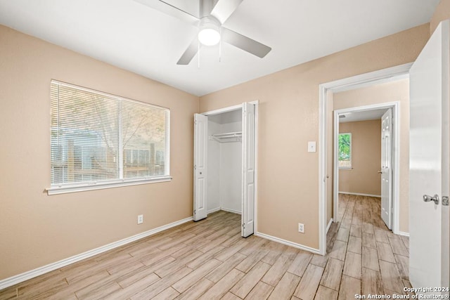 unfurnished bedroom with ceiling fan, a closet, and light hardwood / wood-style flooring