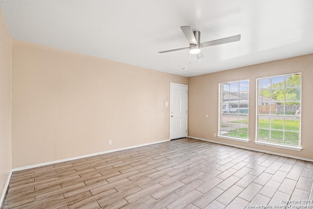 spare room with light hardwood / wood-style floors and ceiling fan