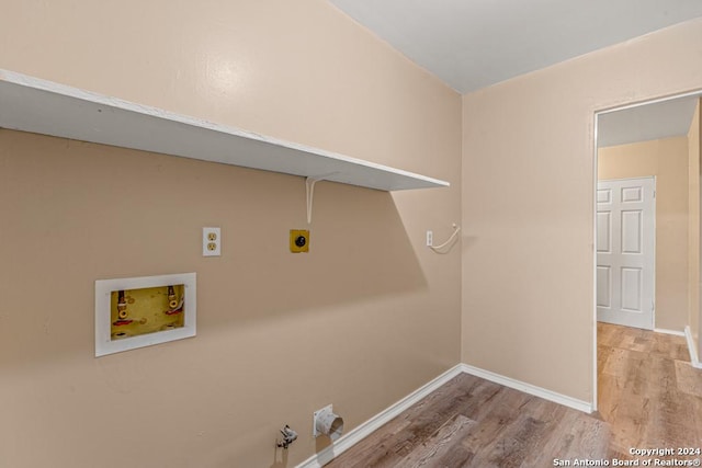 washroom with hookup for a gas dryer, hookup for an electric dryer, washer hookup, and light hardwood / wood-style flooring