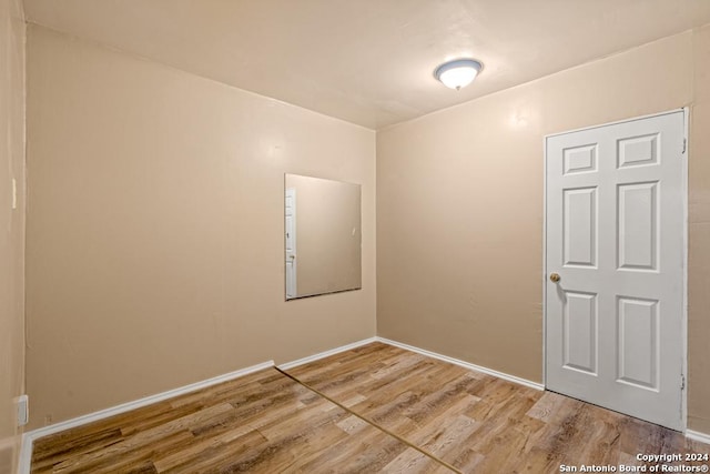 unfurnished room with hardwood / wood-style flooring