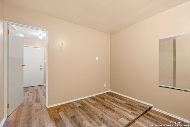 empty room with hardwood / wood-style floors