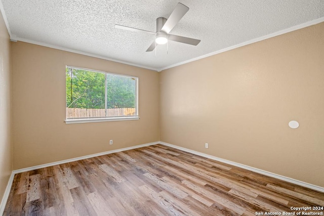 unfurnished room featuring a textured ceiling, ornamental molding, ceiling fan, and light wood-type flooring