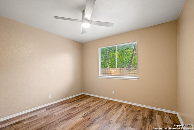 spare room featuring ceiling fan and light hardwood / wood-style floors