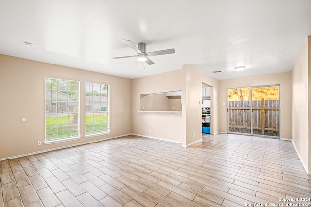 empty room with ceiling fan and light wood-type flooring