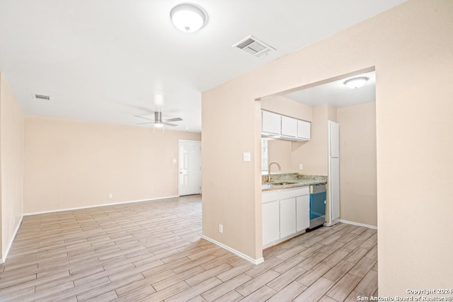 kitchen with sink, stainless steel dishwasher, white cabinets, and ceiling fan