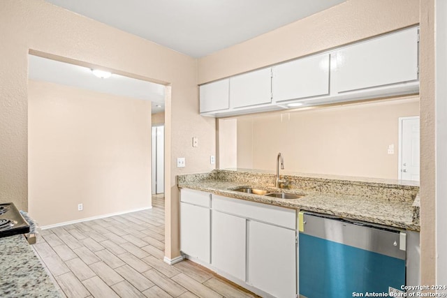 kitchen with white cabinetry, light stone countertops, sink, and stainless steel dishwasher