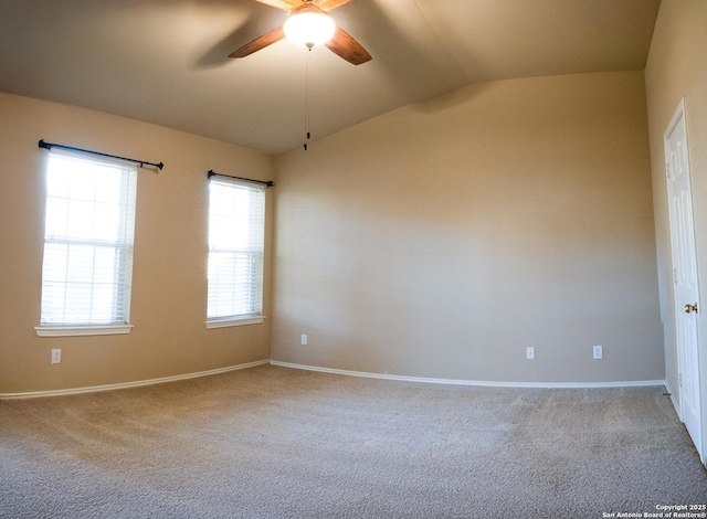 carpeted empty room with ceiling fan and vaulted ceiling