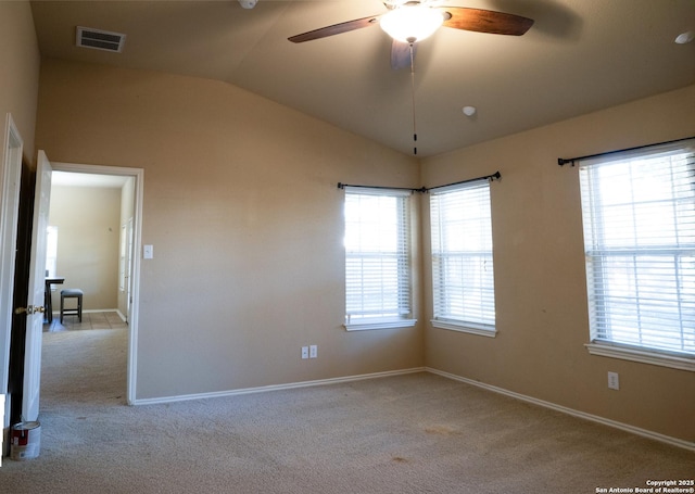 unfurnished room featuring light carpet, a wealth of natural light, and lofted ceiling