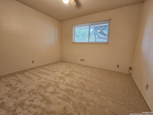 spare room with light carpet and a textured ceiling