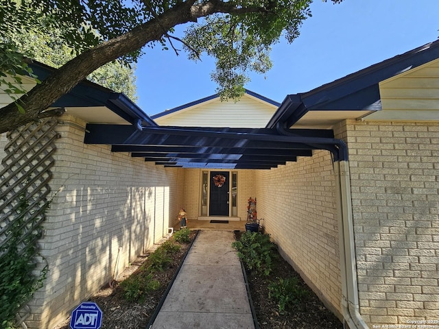 doorway to property with a carport