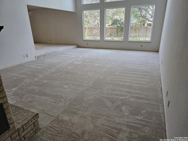 unfurnished living room featuring light carpet