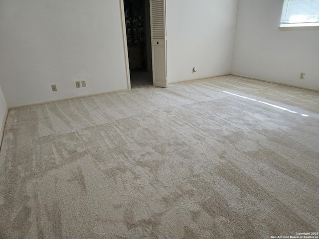 unfurnished bedroom featuring light carpet