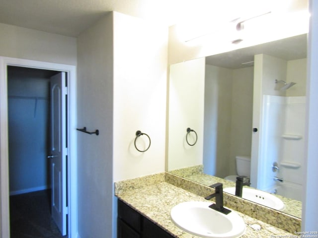 full bathroom with vanity, bathtub / shower combination, and toilet