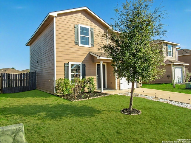 view of front of property featuring a garage and a front yard