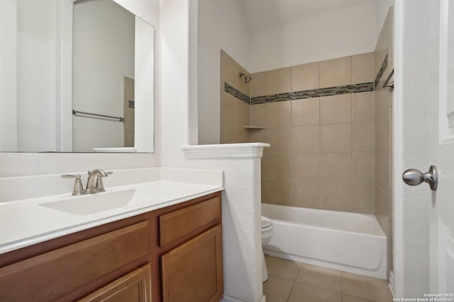 full bathroom featuring tiled shower / bath, tile patterned floors, toilet, and vanity