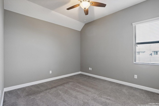 carpeted empty room with ceiling fan and lofted ceiling