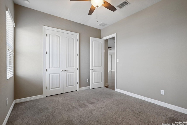 unfurnished bedroom with a closet, ceiling fan, and carpet flooring