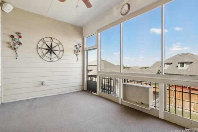 unfurnished sunroom featuring ceiling fan