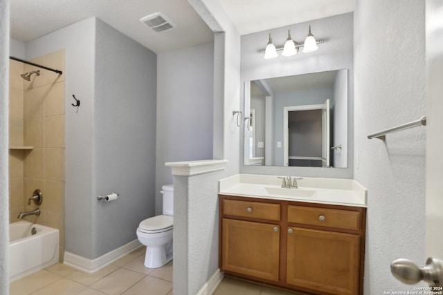 full bathroom featuring vanity, tiled shower / bath combo, tile patterned floors, and toilet