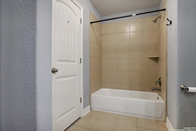 bathroom featuring tiled shower / bath, tile patterned floors, and a textured ceiling