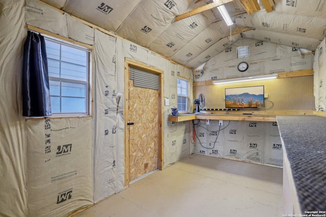 interior space with vaulted ceiling and a workshop area