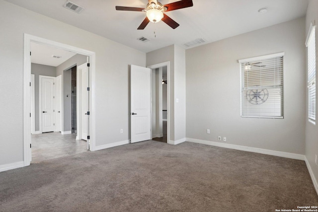 unfurnished bedroom featuring ceiling fan and carpet