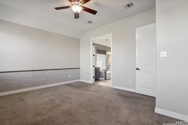 empty room with ceiling fan, carpet flooring, and vaulted ceiling