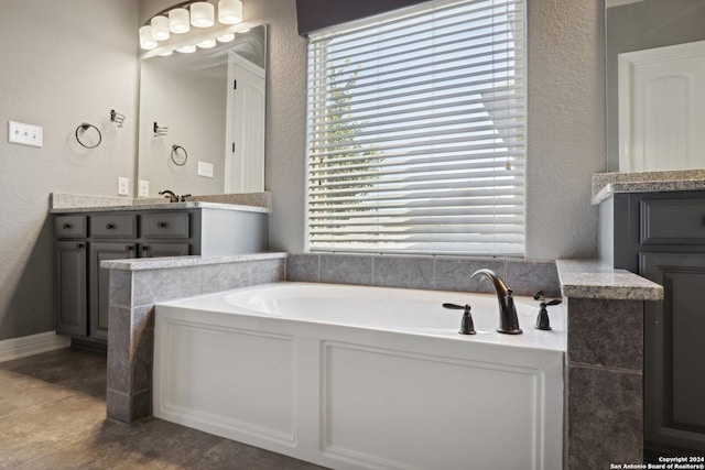 bathroom featuring vanity and a washtub