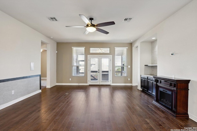 unfurnished living room with french doors, ceiling fan, and dark wood-type flooring