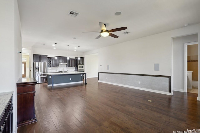 living room featuring dark wood-type flooring, sink, and ceiling fan