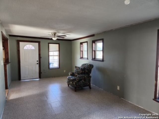 foyer entrance with ceiling fan