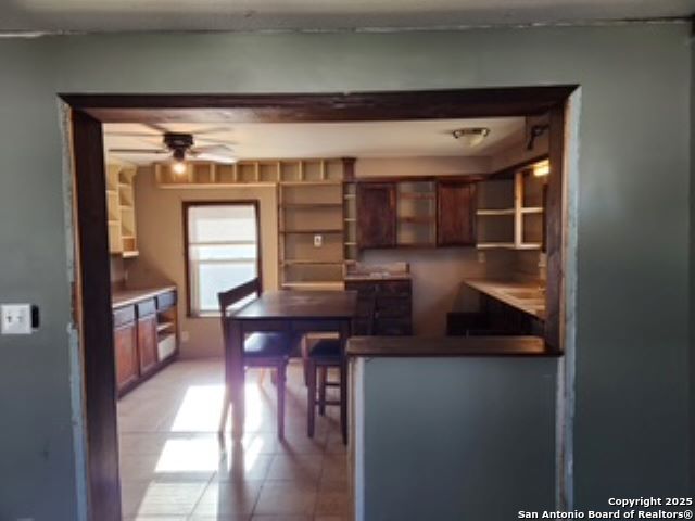 kitchen featuring light tile patterned flooring and ceiling fan