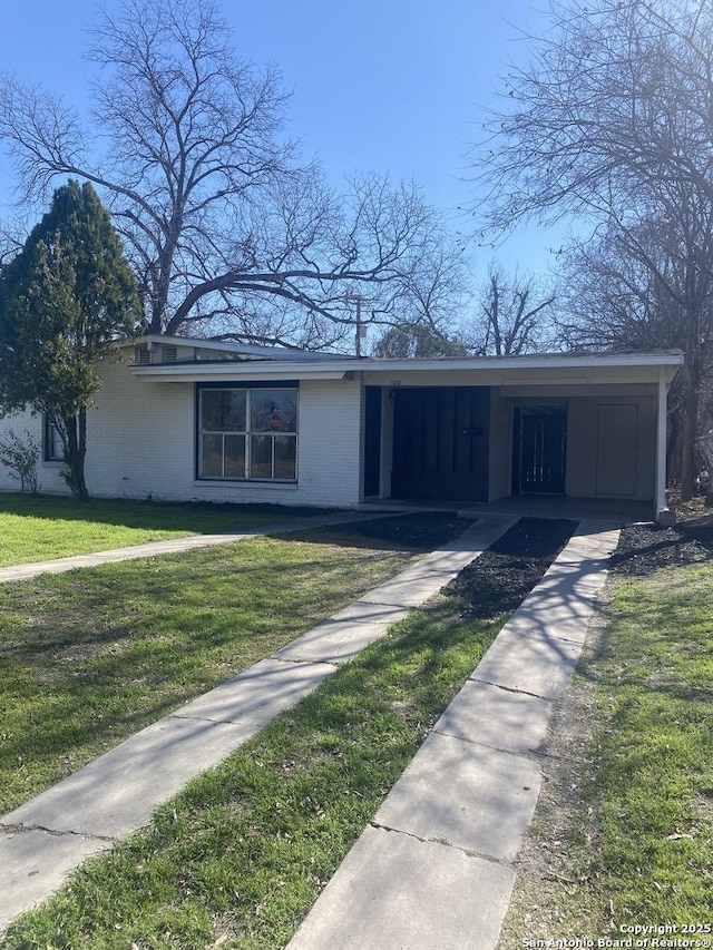 ranch-style house with a front lawn and a carport