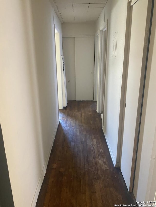 corridor with dark wood-type flooring