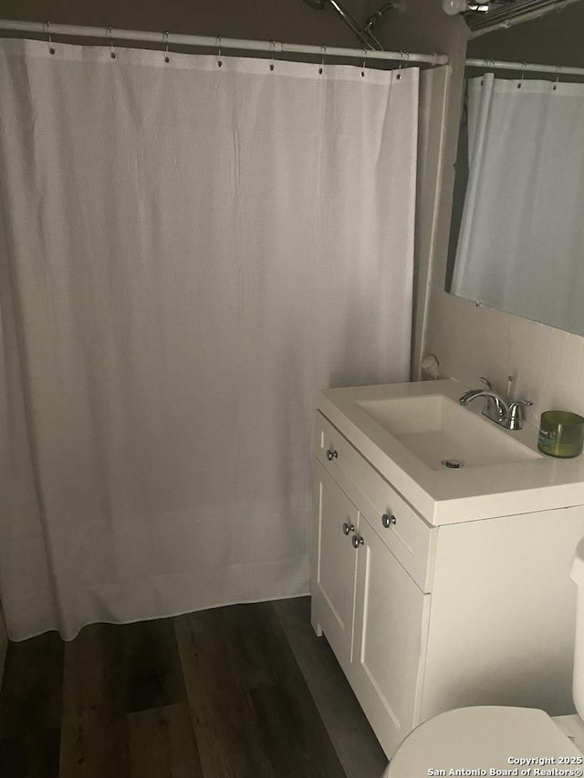 bathroom featuring vanity, toilet, and hardwood / wood-style floors