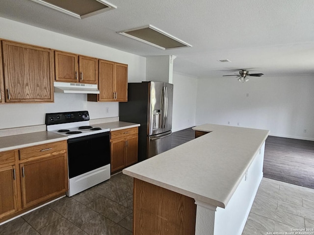 kitchen featuring stainless steel fridge with ice dispenser, a textured ceiling, a kitchen island, range with electric cooktop, and ceiling fan