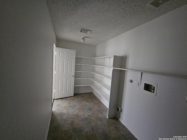 laundry room with hookup for a gas dryer, hookup for a washing machine, and a textured ceiling