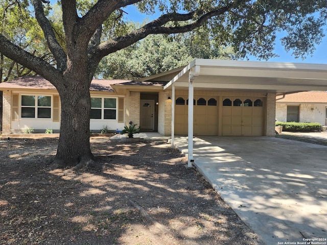 single story home featuring a garage and a carport