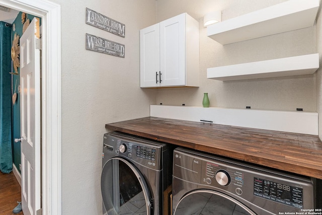 washroom featuring cabinets and independent washer and dryer